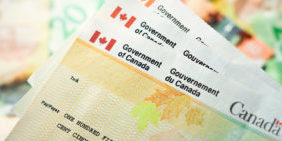 Canada Government Benefit Cheques with Money Background/Stimulus Cheque